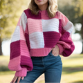 Woman wearing a pink and white striped sweater outdoors