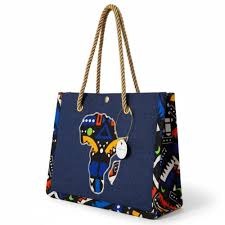 Blue tote bag with colorful African continent design and rope handle on a white background