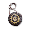 Round bag with decorative elements on a white background