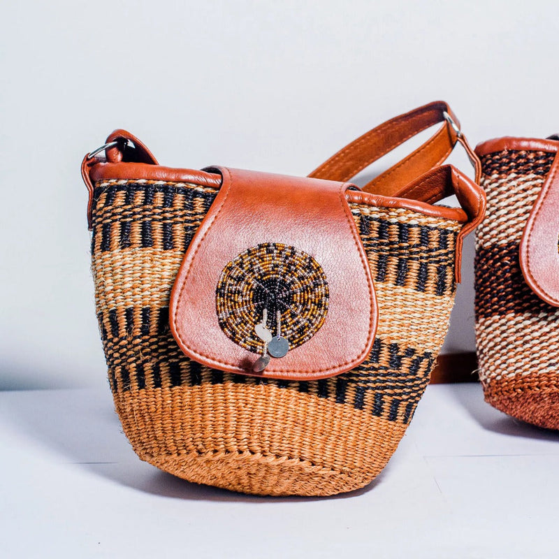 Two woven bags with decorative elements on a light background