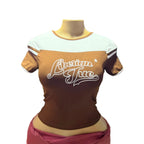 Mannequin wearing a brown and white shirt with 'American True' text in a store setting
