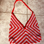 Red and white striped bikini top on a tiled floor