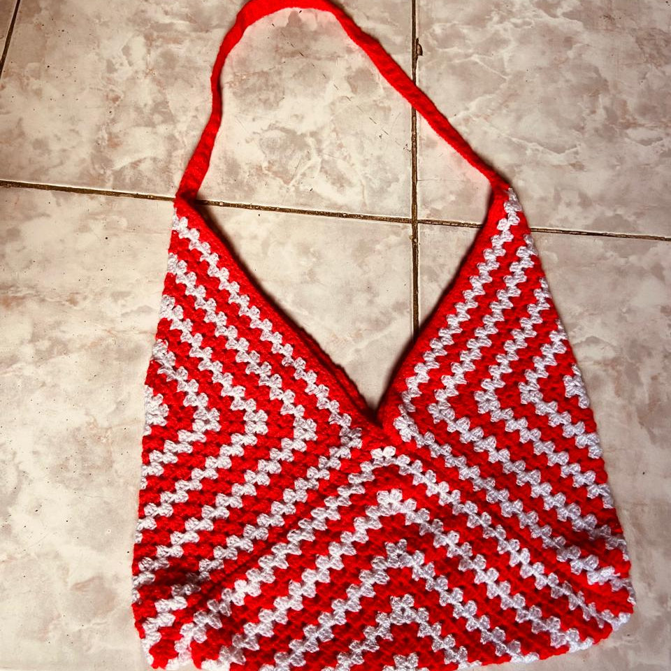 Red and white striped bikini top on a tiled floor