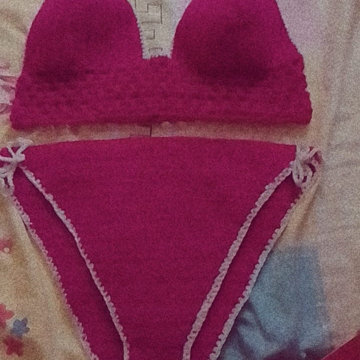 Pink bikini set on a patterned fabric background