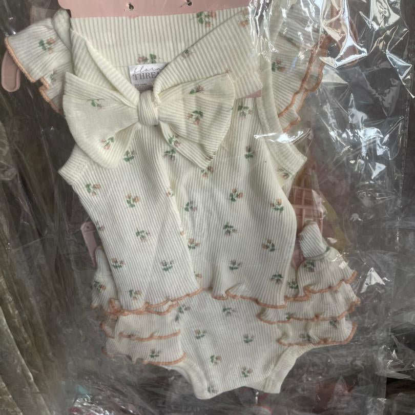 Baby clothing set with floral patterns in clear packaging