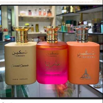 Perfume bottles and packaging displayed on a screen with a beige background