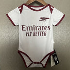 Baby onesie with Emirates branding on a hanger against a neutral background