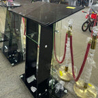 Black glass display stand with hookahs in a store setting