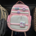Pink and gray backpack with cartoon character on a shelf