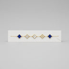 Bracelet with blue clover-shaped charms on a white card