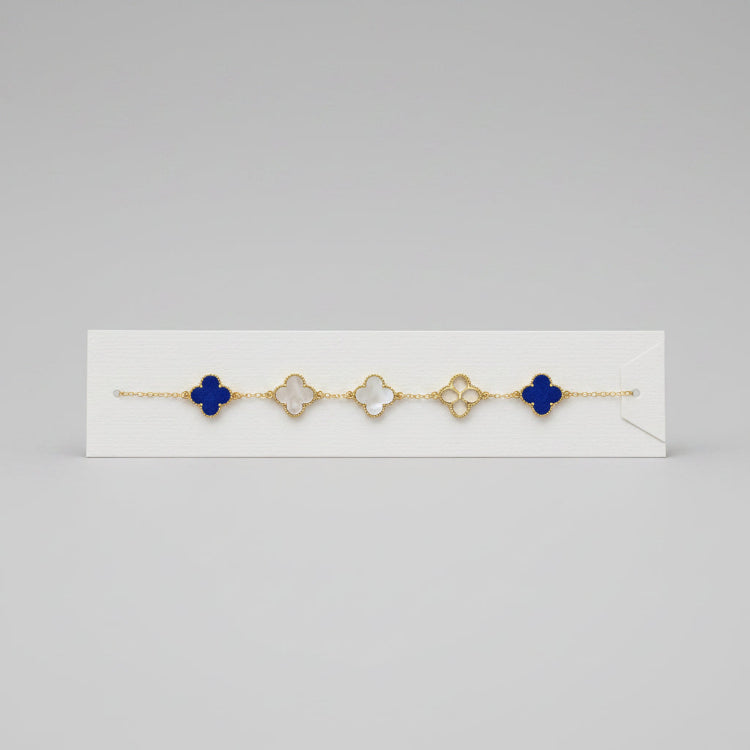 Bracelet with blue clover-shaped charms on a white card