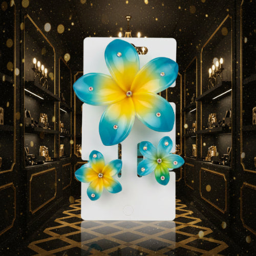 Set of blue and green flower-shaped hair clips on a white surface.