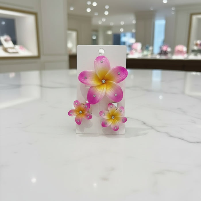 Colorful flower-shaped hair clips on a white card with a blurred background