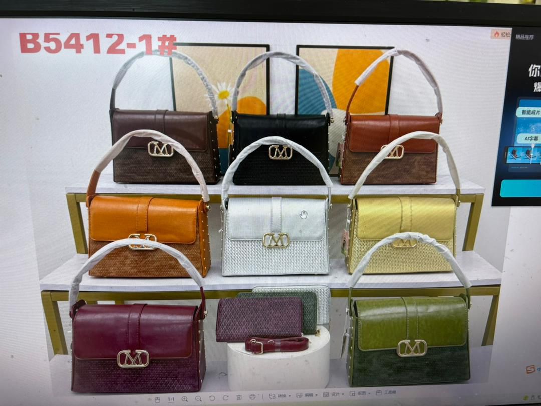 Display of various handbags in different colors on a shelf.