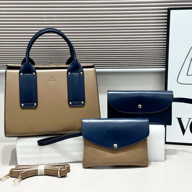 Set of handbags in beige and navy with a Vogue poster in the background