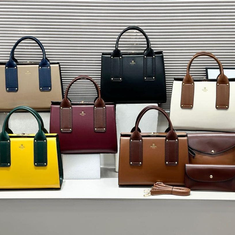 Collection of various handbags in different colors on a white surface with a blurred background.