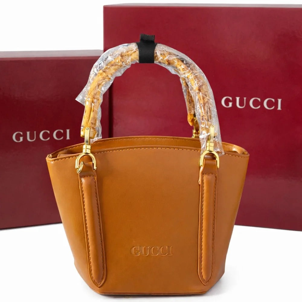 Brown Gucci handbag with clear handle cover on a white background