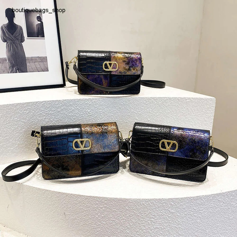 Three black handbags with gold accents on a white surface.