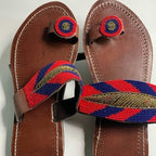 Pair of brown sandals with colorful straps on a white background
