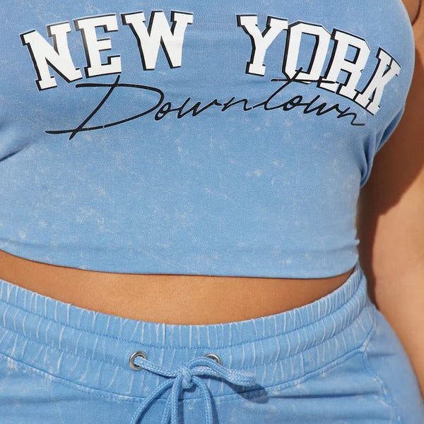 Blue strapless top with 'New York Downtown' text on a person wearing blue pants.