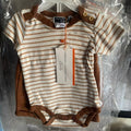 Baby onesie with striped design and brown accents on a hanger, brand tag visible.