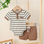Baby outfit with striped onesie and brown shorts hanging on a wooden rack.