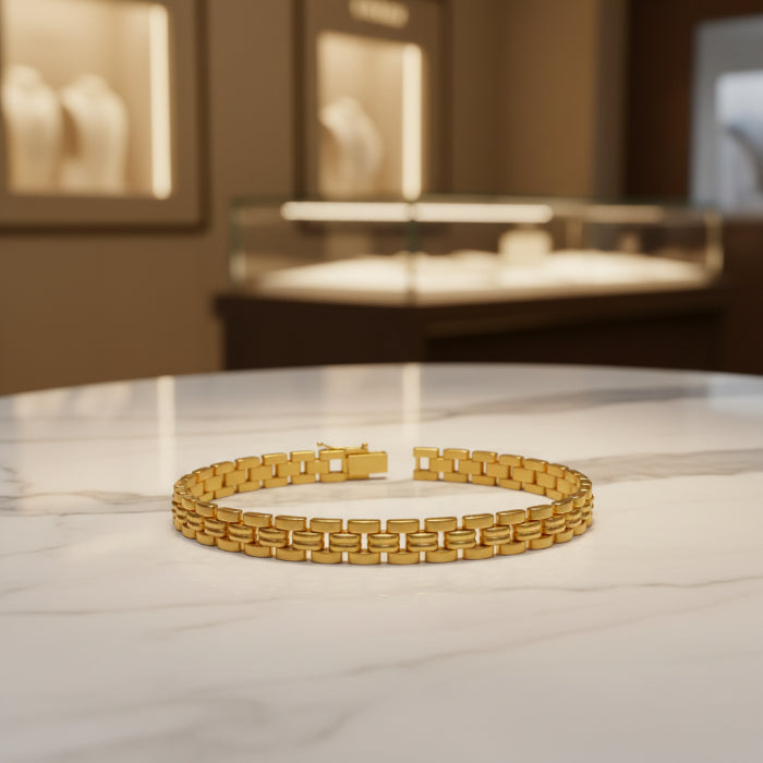 Gold bracelet on a white card with a reflective surface background
