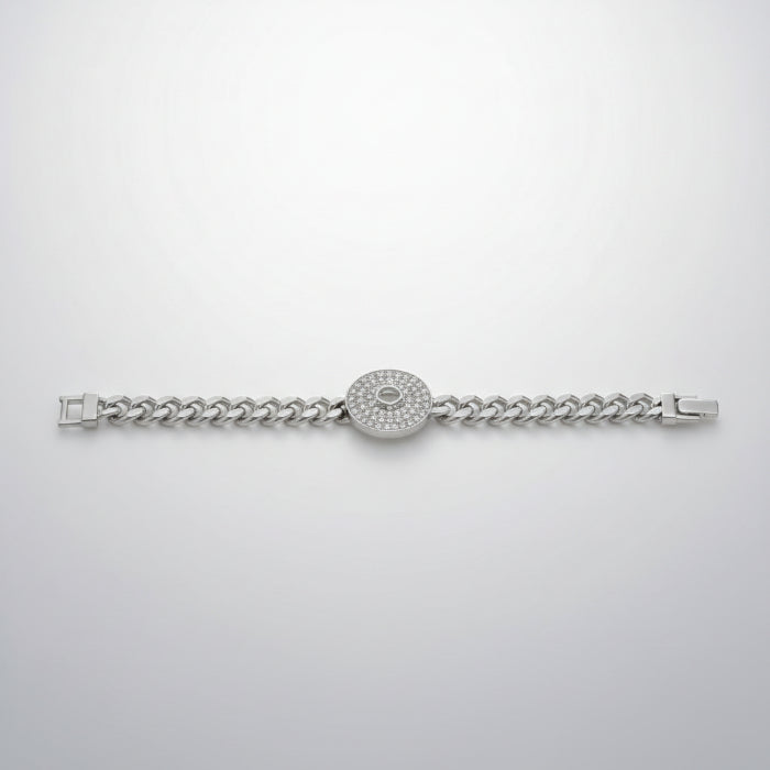 Silver bracelet with clear stones in packaging on a reflective surface