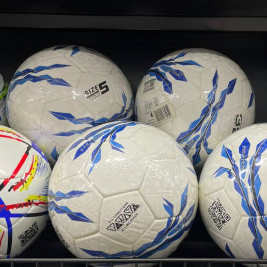 Shelf with soccer balls and a basketball
