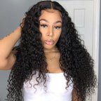 Woman with long, curly black hair wearing a white top against a neutral background