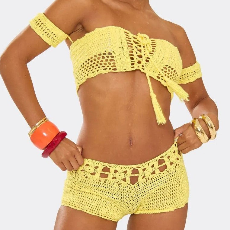 Yellow crochet bikini set on a plain background