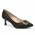 Black high-heeled shoe with gold decorative element on a blue surface, surrounded by other shoes.