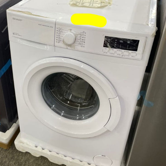 White dryer with a yellow tag on a gray floor
