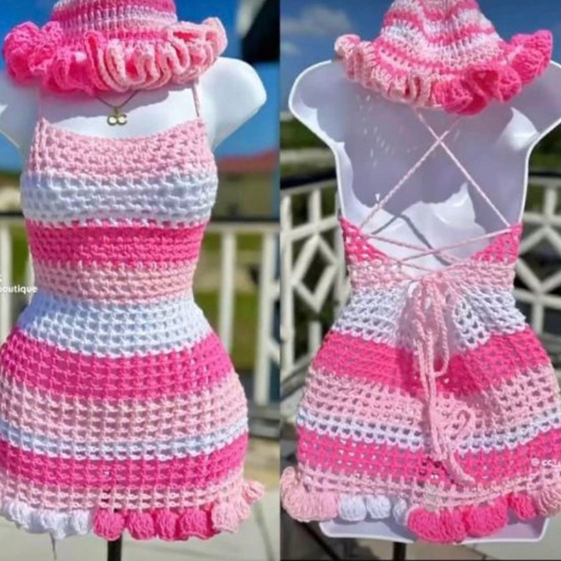 Crocheted pink and white dress on a mannequin with a blurred outdoor background.