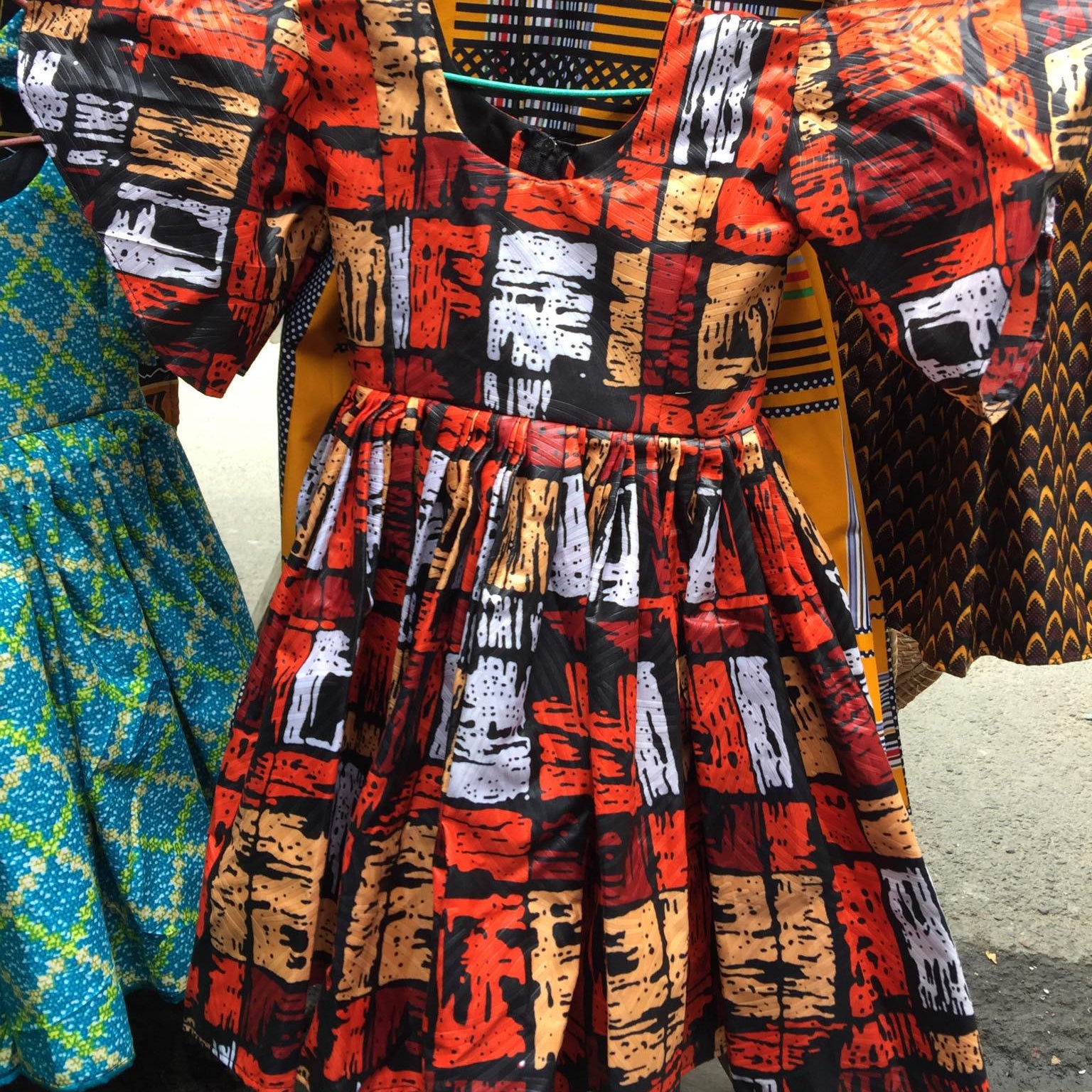 Colorful African print dresses hanging on a rack