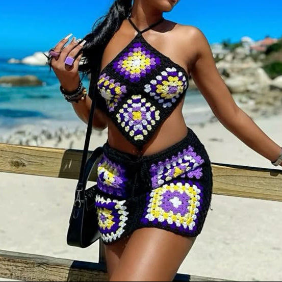 Woman wearing a colorful crochet outfit by the beach