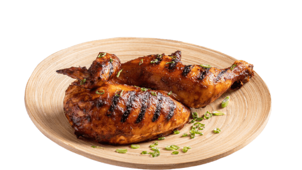 Grilled chicken on a wooden plate with a white background. half roasted chicken from Town Bakery