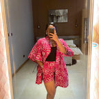 Person wearing a red and white patterned outfit taking a mirror selfie.