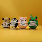 Four crochet animals with motivational messages on a yellow background
