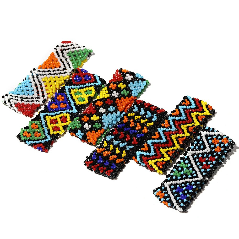 Colorful beaded cross patterns on a white background