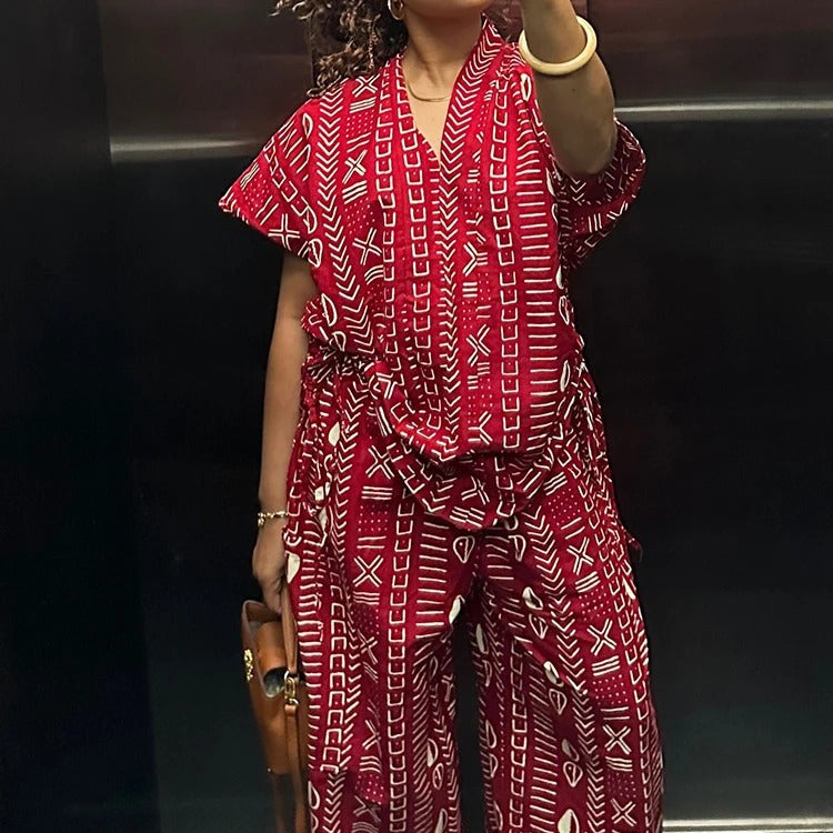 Person wearing a red patterned jumpsuit in an elevator.
