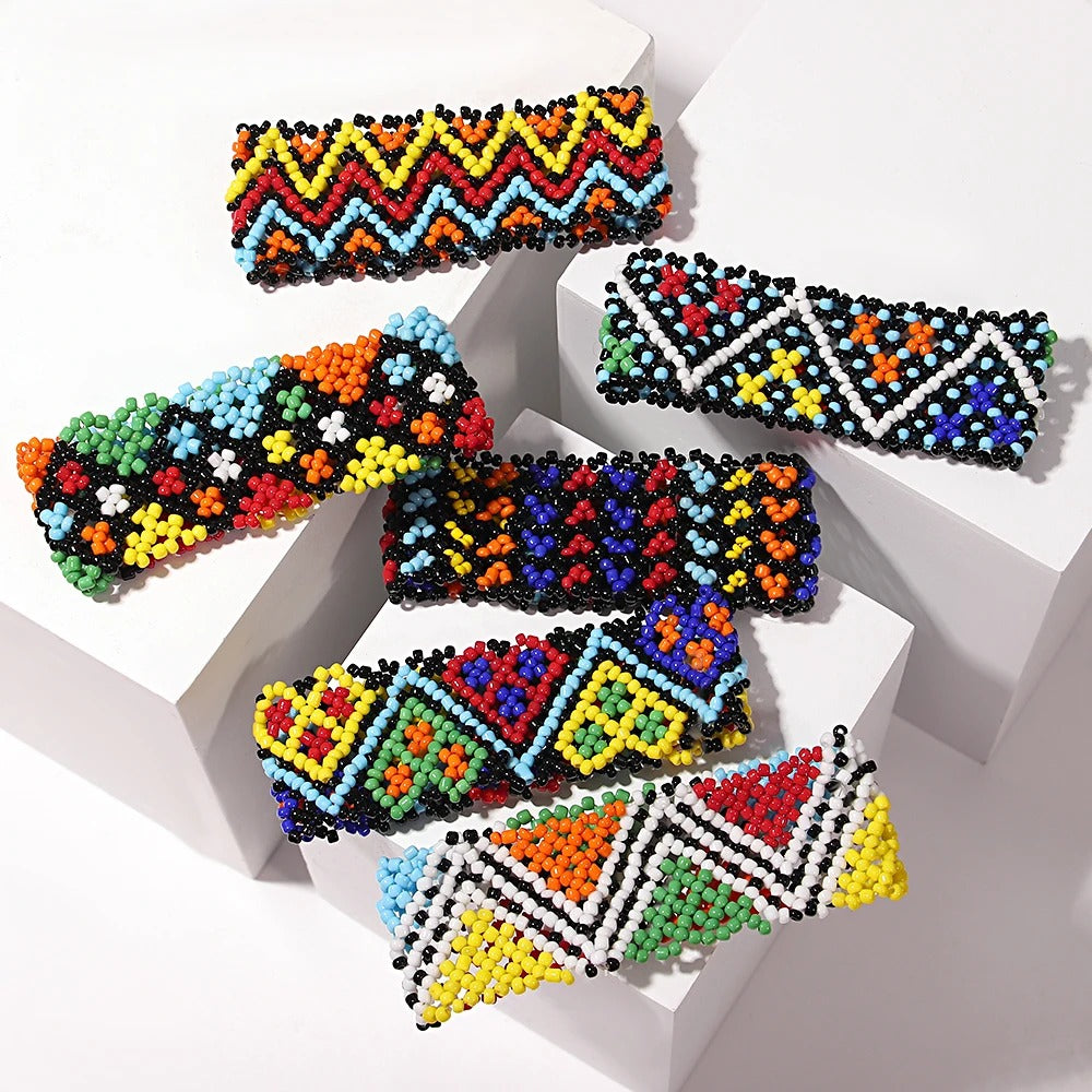 Colorful beaded hair clips on a white background