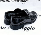 Black patent leather shoes on a white background with 'Salvo Sovaggio' branding.