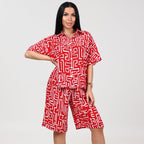 Woman wearing a red and white patterned outfit on a white background