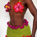 Colorful crochet bikini set with a red and pink floral top on a white background