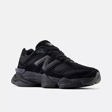 Black New Balance sneakers on a light gray background