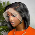 Person wearing a black bob wig with a clear lace front, set against a neutral background.