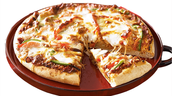 Personal-sized pizza with a slice removed on a red tray. vegetarian pizza from Town Bakery 2